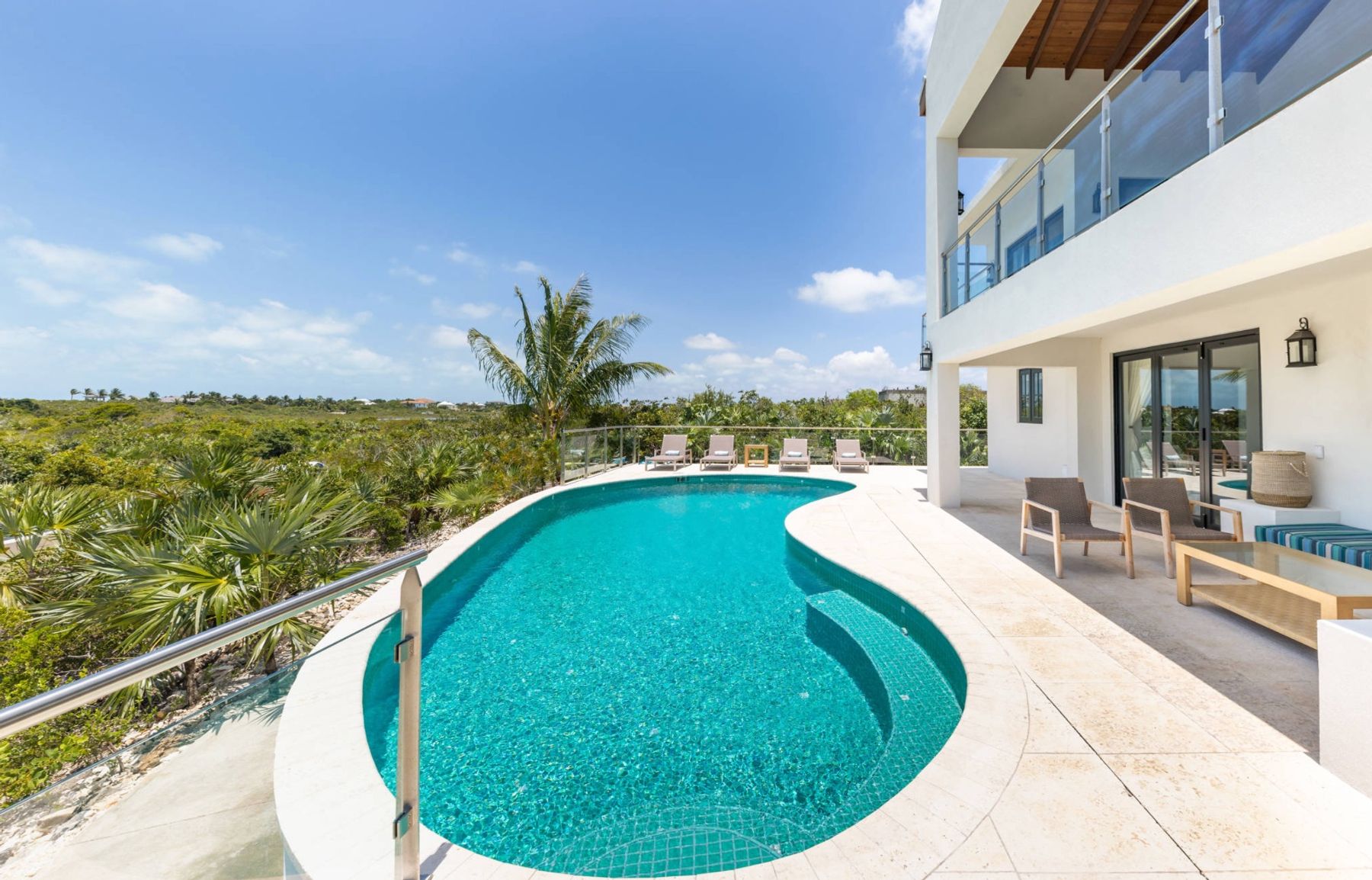 View of pool showing the terrace on the pool level and the main level outdoor terrace